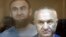 Raul Arashukov (front) and his son Rauf attend a court hearing in Moscow in July 2020.