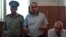 Azerbaijani journalist Eynulla Fatullayev stands trial for possession of drugs in 2010. He was found guilty of the charges, which Amnesty International described as "fabricated," and sentenced to 2 1/2 years imprisonment.