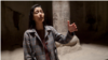 Armenia - visitors sing in a stone chapel at the Geghard monastery complex - underground cave church - screen grab