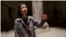 Armenia - visitors sing in a stone chapel at the Geghard monastery complex  - underground cave church - screen grab