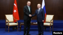 Turkish President Recep Tayyip Erdogan (right) meets with Russian President Vladimir Putin on the sidelines of a regional summit in Astana on October 13. 