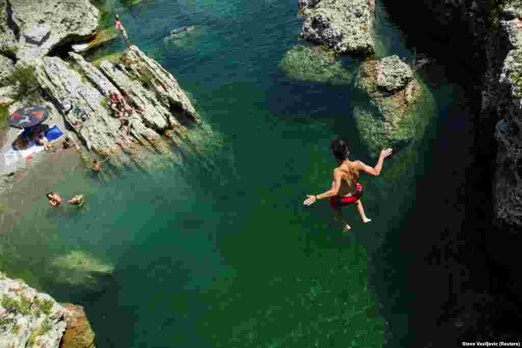 A boy jumps into the Cijevna River to cool off near Tuzi as a heatwave hit Montenegro. (Reuters/Stevo Vasiljevic)