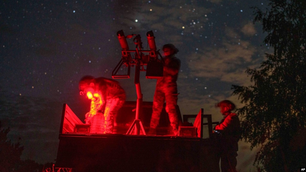 A volunteer for an air-defense unit prepares a machine gun near Bucha, Kyiv region, Ukraine, in August.