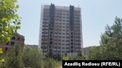 Azerbaijan -- Baku. At least 15 people have been killed in a fire that that ripped through a 16-story apartment building in Azerbaijan's capital, 28 June 2015