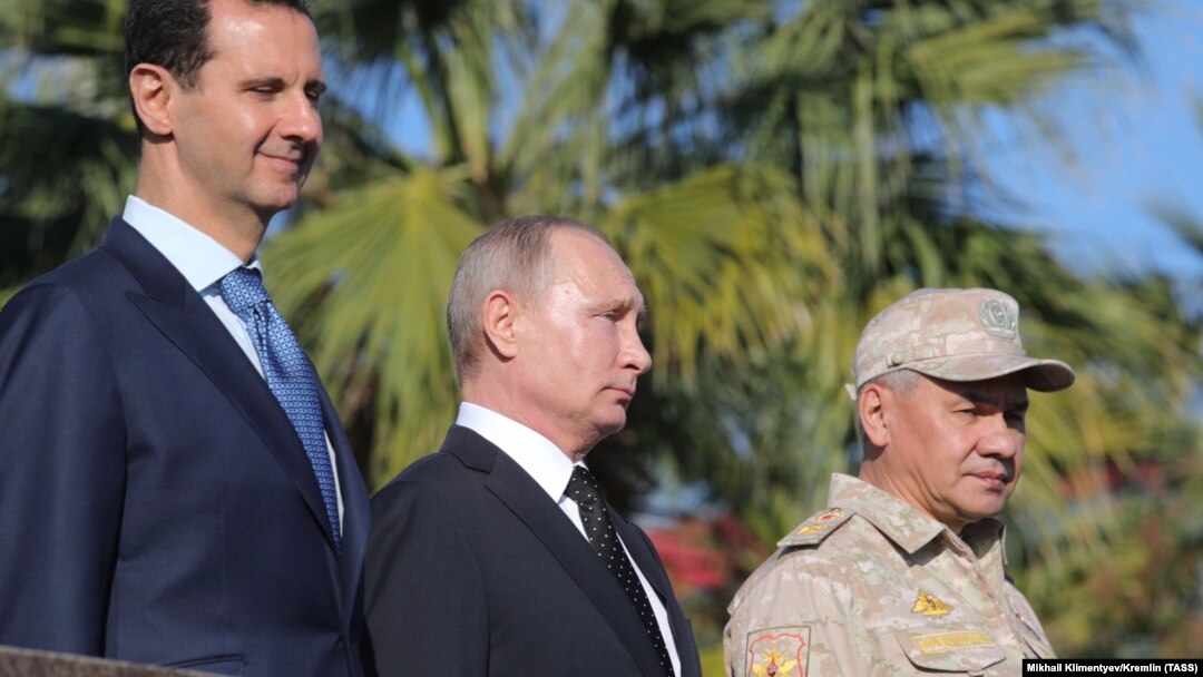 Syrian President Bashar al-Assad (left), Russian President Vladimir Putin (center), and Russian Defense Minister Sergei Shoigu visit the Hmeimim military base in Latakia Province on December 11.