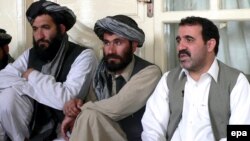 Ahmed Wali Karzai (right), the president's brother, sits in early April with other members of Kandahar's provincial council.