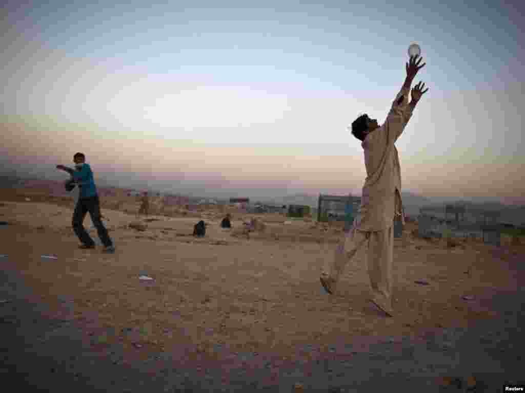 Afghan youths play at a cemetery in Kabul. (Ahmad Masood for Reuters)