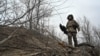 A Ukrainian soldier of the 118th Separate Mechanized Brigade carries an anti-drone rifle at a front line in the Zaporizhzhya region, Ukraine, on December 3.