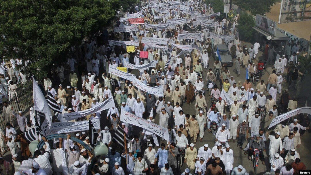 Pakistani protesters hold banners and flags while taking part in an anti-American protest rally in Karachi on September 21.