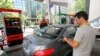 A gas station attendant fills a car at a petrol station in the Iranian capital Tehran, May 25, 2015. File photo