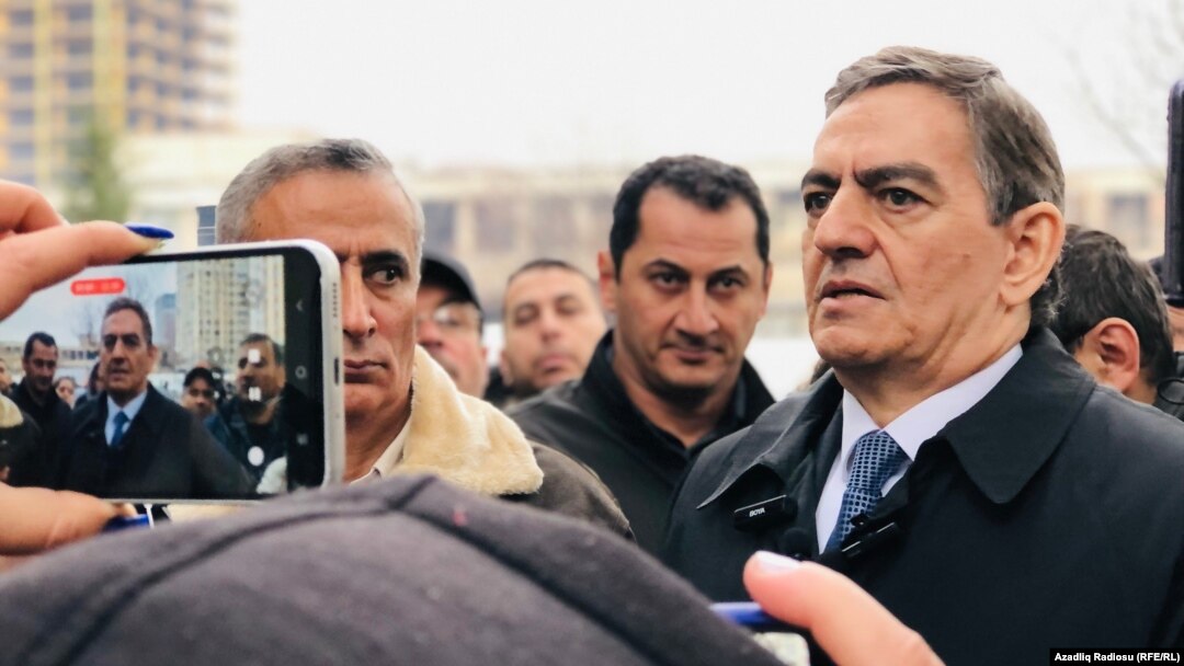 Azerbaijani opposition leader Ali Karimli (right) outside the Nasimi District Court in Baku on December 2.