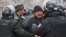 Kazakh police try to pacify protesters in Almaty who were rallying against measures taken by the authorities to suppress demonstrations in the oil town of Zhanaozen. At least 16 people were killed in violent clashes between police and demonstrators.