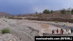 Children in North Waziristan play in a pond after a rainstorm. (file photo)