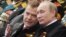 Russia -- Dmitriy Medvedev and Vladimir Putin watch a military parade during the nation's Victory Day celebrations in Moscow on May 9, 2011
