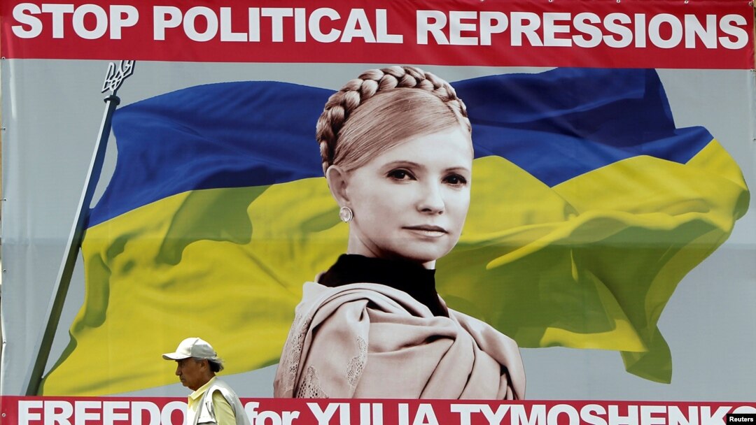 A man walks past a billboard with a portrait of jailed Yulia Tymoshenko in central Kyiv.