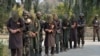 FILE: Officials of Afghanistan's National Directorate Security (NDS) intelligence agency escort alleged Taliban fighters after they are presented to media in Jalalabad in January.