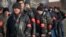 Crimean pro-Russian volunteers line up in a square in front of a statue of Vladimir Lenin in Simferopol on March 14.