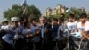 Afghan presidential candidate Abdullah Abdullah talks with a group of cyclists in Kabul on June 6.