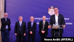 Serbian President Aleksandar Vucic (right) couldn't help cracking a joke at a meeting with health specialists and epidemiologists on February 26 in Belgrade.