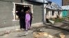 Люди дивляться через розбите вікно в будинок, пошкоджений ракетним ударом Росії по Миколаєву, Україна, 11 квітня 2024 року