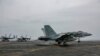 AT SEA -- An F/A-18E attached to the "Sidewinders" of Strike Fighter Squadron (VFA) 86 makes an arrested landing on the flight deck of the aircraft carrier USS Abraham Lincoln (CVN 72), in the Gulf, in this picture taken and released by U.S. Navy on Augus