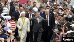 Kazakh President Nursultan Nazarbaev gestures to the crowd during the opening ceremony of the Hazrat Sultan mosque in Astana in July 2012.