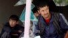 Afghan men look out through a broken window at the site of a suicide attack in Kabul on April 22.