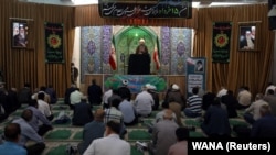 Iranian worshippers attend the Friday Prayers while maintaining social distancing in Tehran Province on June 12.