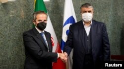 According to the International Atomic Energy Agency, the agreement was reached on December 15 by IAEA Director-General Rafael Mariano Grossi (left) and the head of Iran's nuclear energy agency Mohammad Eslami. (file photo) 