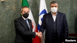IAEA Director-General Rafael Grossi (left) with the head of Iran's Atomic Energy Organization, Mohammad Eslami in Tehran. 