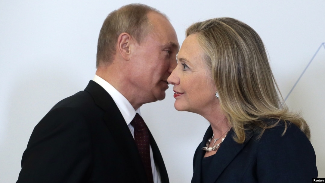Russian President Vladimir Putin greets then-U.S. Secretary of State Hillary Clinton upon her arrival at an APEC summit in Vladivostok in 2012.