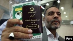 Iran - a man holds his passport in his hand . UNDATED