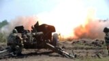 Ukraine -- Graduates of the department for the preparation of reserve officers of Kharkiv Polytechnic University fire from an anti-tank gun MT-12 Rapira during their graduation exercises on Chuhuiv shooting range, not far from Kharkiv, July 23, 2015