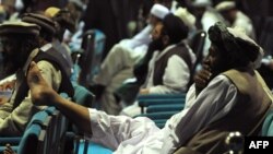 Delegates to the recent so-called Peace Jirga listen to speeches in the main tent on June 4.