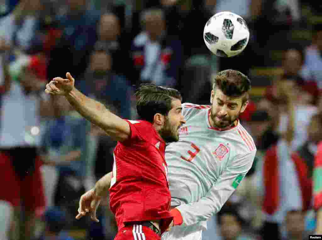 Soccer Football - World Cup - Group B - Iran vs Spain - Kazan Arena, Kazan, Russia - June 20, 2018 Iran's Karim Ansarifard in action with Spain's Gerard Pique REUTERS/Toru Hanai