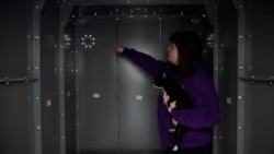 Kateryna Storozhuk shows the Life Capsule home shelter she installed in the spare room of her apartment in Bucha, Ukraine.