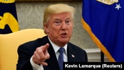 U.S. -- U.S. President Donald Trump speaks during his meeting with former U.S. Secretary of State Henry Kissinger in the Oval Office of the White House in Washington, U.S., October 10, 2017.