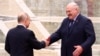 Belarusian leader Alyaksandr Lukashenka (right) greets Russian President Vladimir Putin in Minsk on November 23. The U.S. Treasury Department stated on December 5 that the Russian government and Belarus's regime "have been working together to coordinate and fund the movement of children from Ukraine to Belarus."