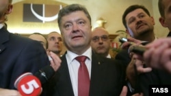 Ukrainian President Petro Poroshenko speaks to journalists as he leaves after a multilateral meeting on Ukraine's crisis on the sidelines of the 10th ASEM summit in Milan on October 17.