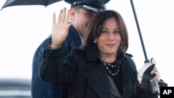 U.S. Vice President Kamala Harris wave as she boards Air Force Two to travel to Europe on March 9. 