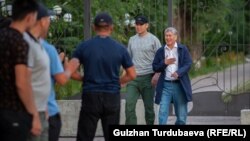Алмазбек Атамбаев жана аны кайтарууга бөлүнгөн УКМКнын кызматкери.