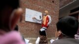 HEALTH-CORONAVIRUS/EGYPT-TEACHER/Reem El-Khouly, a 12-year-old girl, teaches children in her neighborhood as schools remain closed during the coronavirus disease (COVID-19) pandemic, at Atmida village in Dakahlia province, Egypt February 7, 2021.