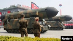 Missiles are driven past the stand with North Korean leader Kim Jong Un and other high-ranking officials during a military parade marking the 105th anniversary of the birth of North Korea's founding father, Kim Il Sung, in Pyongyang on April 15.