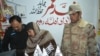 FILE: Pakistani police and and paramilitary forces raid a shop a selling pro-Taliban literature in Quetta, Balochistan.