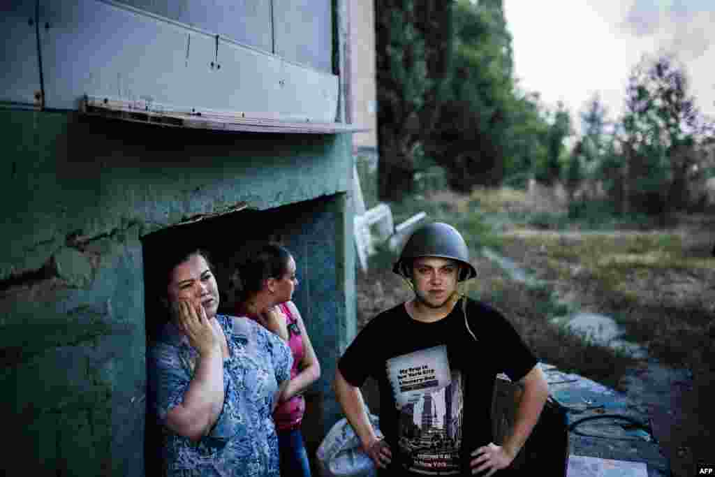 People stand at the entrance of a makeshift bomb shelter in Donetsk, Ukraine. (AFP/Dimitar Dilkoff)