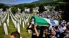 BOSNIA-HERZEGOVINA -- Men carry a coffin at a graveyard during a mass funeral in Potocari near Srebrenica, July 11, 2020