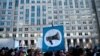 Activists gather before a hearing at the Federal Communications Commission on December 14 in Washington, D.C.