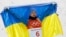 Olexandr Abramenko celebrates with a Ukrainian flag after taking gold in the men's aerials event at the Winter Olympics. 