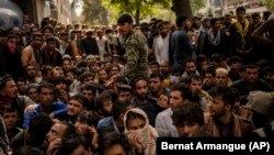 Afghans outside a bank as they try to withdraw money in Kabul on September 12.