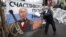 UKRAINE – A pro-European integration supporter washes a banner with an image of Russian President Vladimir Putin near a barricade in Independence Square where the supporters are holding a rally, in Kyiv January 9, 2014